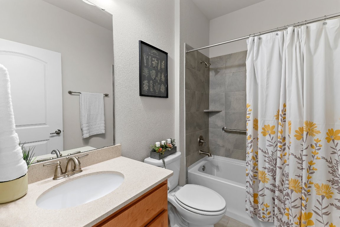 608 Kite Ridge Street Georgetown, TX 78633 - Photo 32 of 39 a bathroom with a sink a toilet and shower