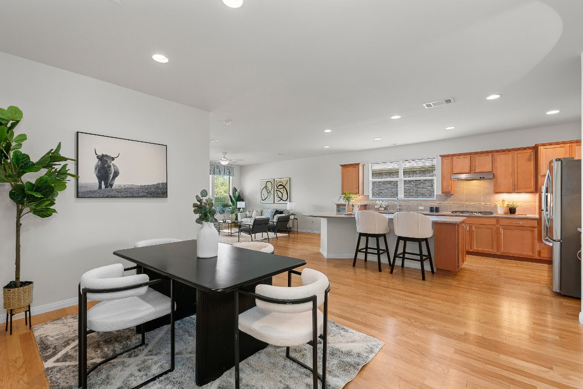 608 Kite Ridge Street Georgetown, TX 78633 - Photo 9 of 39 a view of a dining room with furniture window and wooden floor