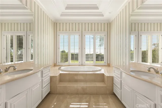 a spacious bathroom with a tub and sink