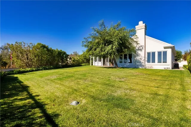 a house view with swimming pool in front of it