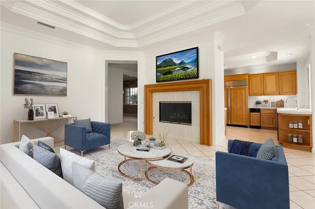 a living room with furniture kitchen view and a fireplace
