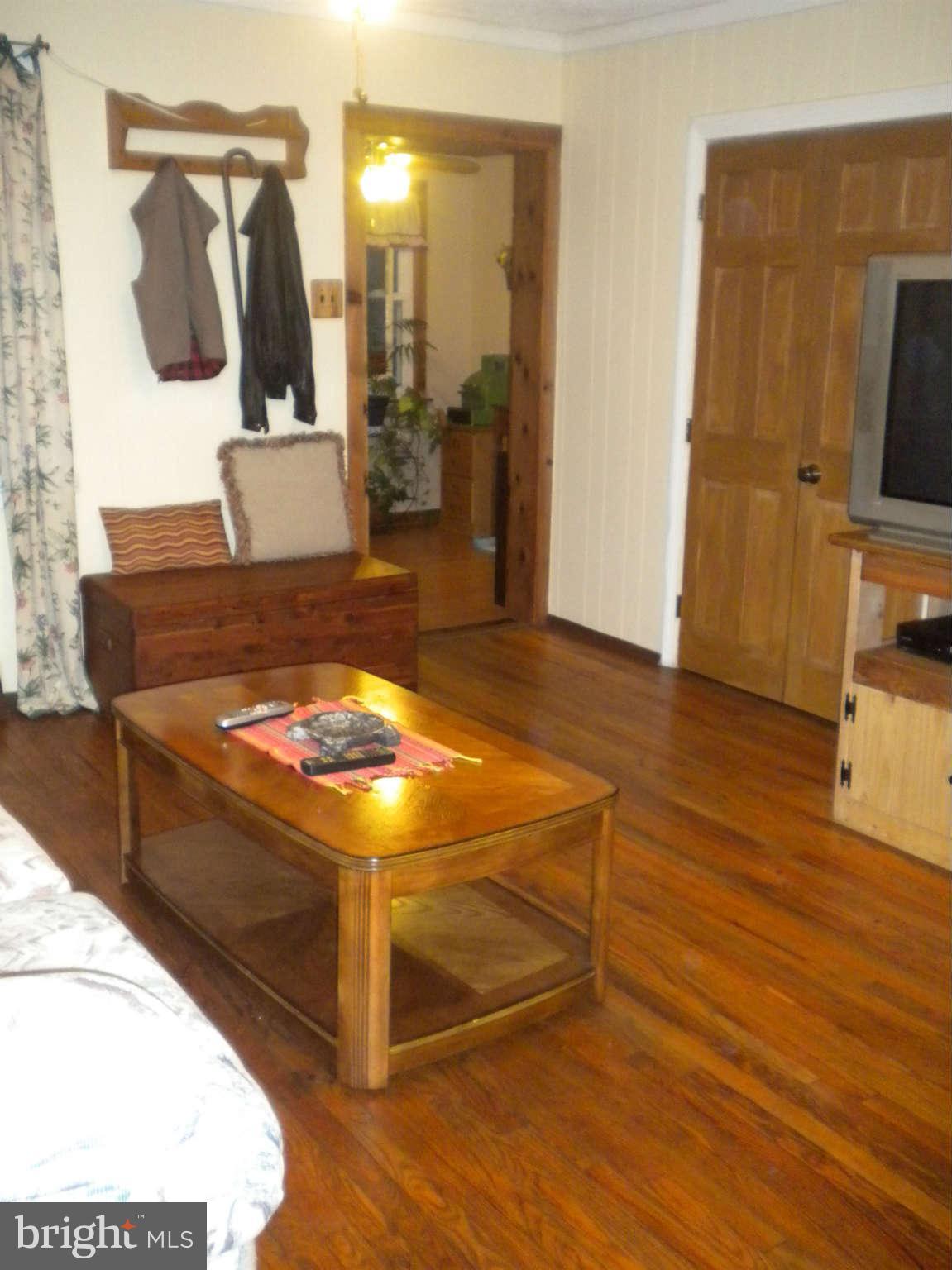 7614 Spruce Road Baltimore, MD 21222 - Photo 20 of 30 a living room with a flat screen tv and a wooden floor