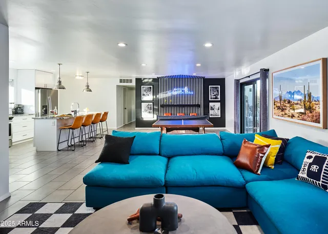 a living room with furniture and kitchen view