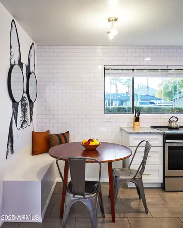 a kitchen with a table chairs and a table