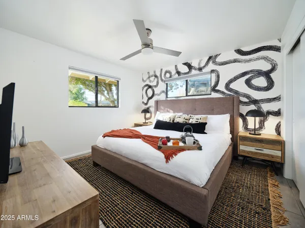 a bedroom with a bed and wooden floor