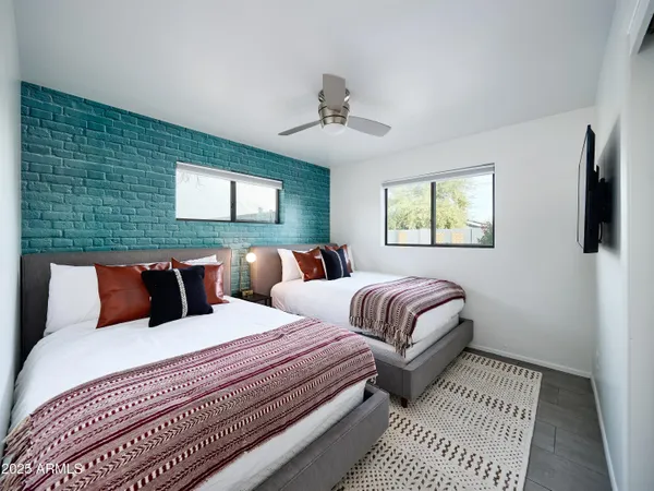 a bedroom with double bed and a window