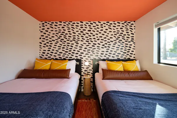 a bedroom with double bed and a window