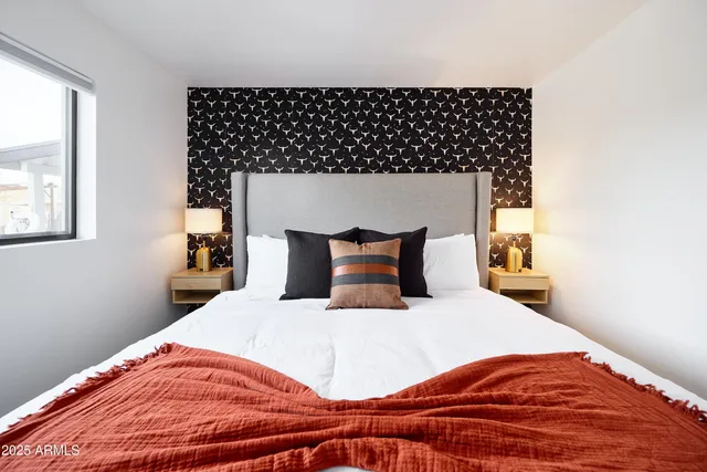 a bedroom with a bed and a window