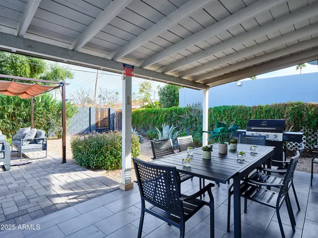 a view of an outdoor dining space with a table and chairs