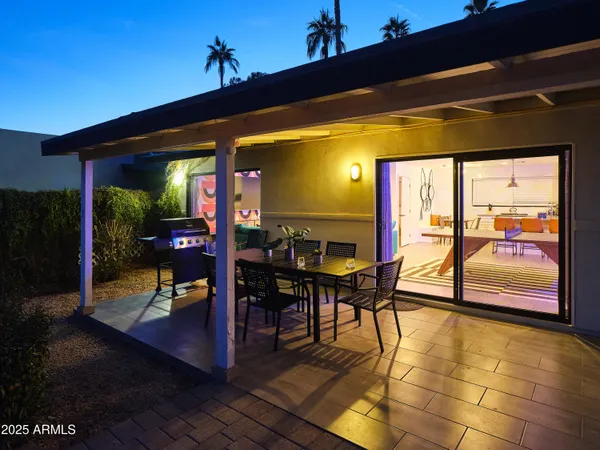 a view of a patio with dining table and chairs with wooden floor