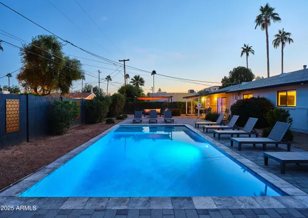 a swimming pool with outdoor seating