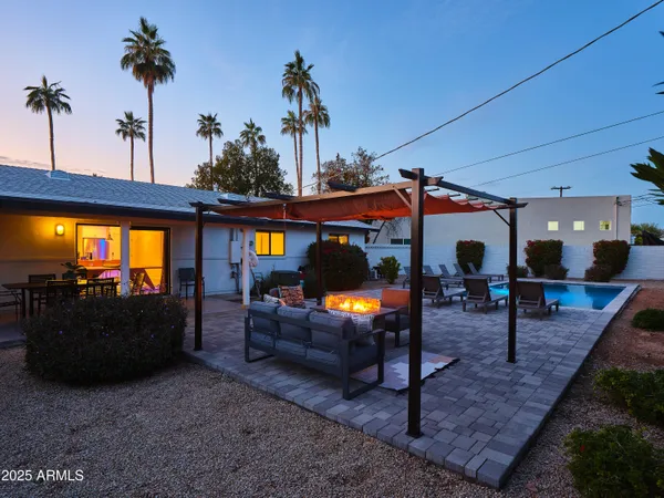 a view of outdoor living space with patio furniture and potted plants