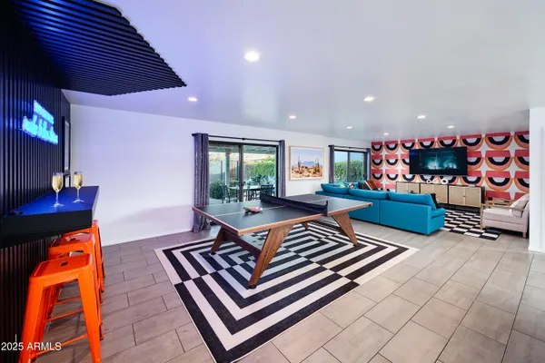 an outdoor living space with furniture and a rug