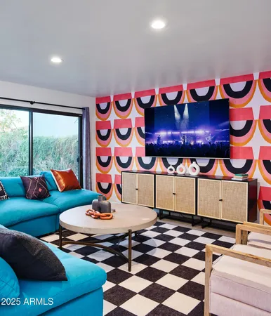 a living room with furniture and a floor to ceiling window