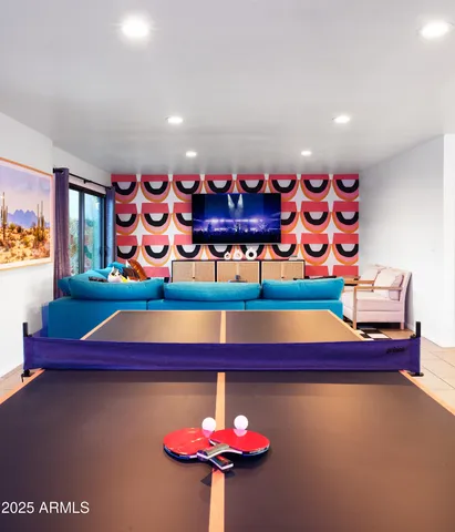 a room with red wall paintings and a table