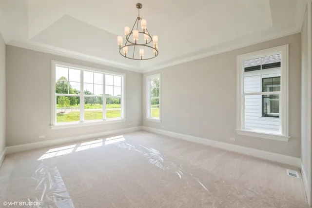 a spacious bathroom with a double vanity sink a large mirror and a bathtub
