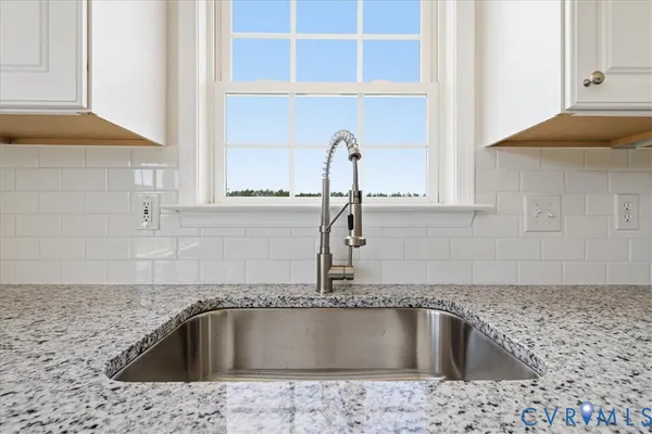 a kitchen with a sink and granite top