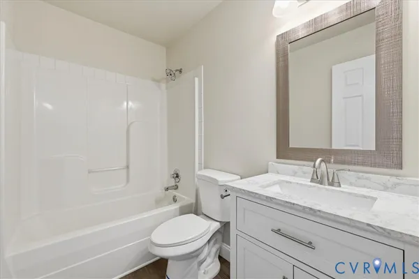 a bathroom with a sink toilet vanity and shower