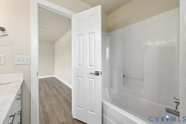 a bathroom with a bathtub and shower
