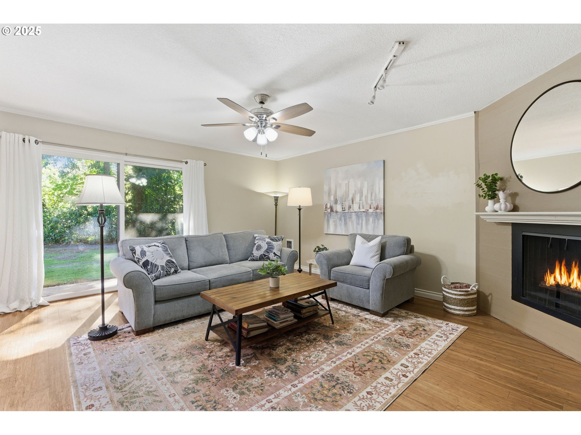 6745 Southwest Scholls Ferry Road, Unit 29 Beaverton, OR 97008 - Photo 4 of 31 a living room with furniture a fireplace and a large window