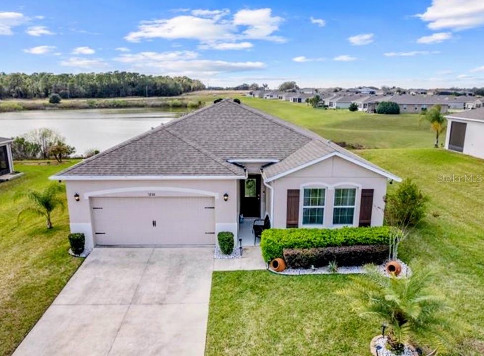 a view of house with river and a garden