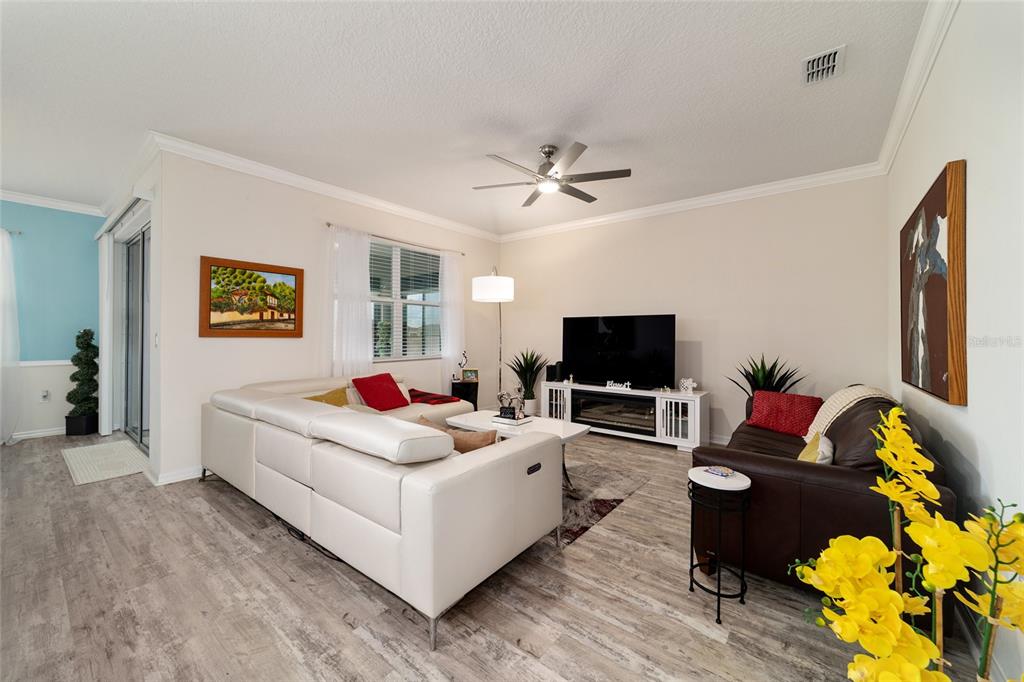 9238 Southwest 60th Terrace Road Ocala, FL 34476 - Photo 12 of 50 a living room with furniture and a flat screen tv