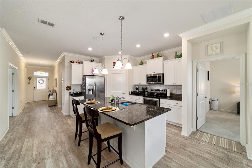 9238 Southwest 60th Terrace Road Ocala, FL 34476 - Photo 20 of 50 a kitchen with a refrigerator and chairs