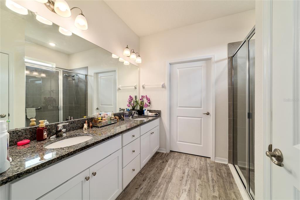 9238 Southwest 60th Terrace Road Ocala, FL 34476 - Photo 31 of 50 a bathroom with a double vanity sink and mirror with shower