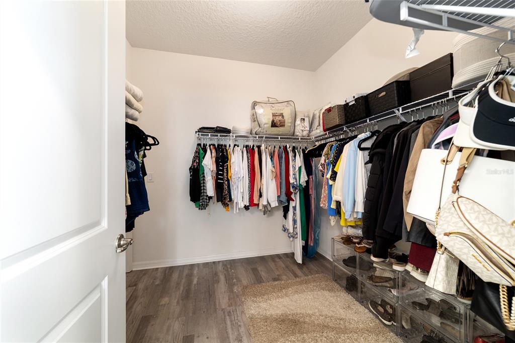 9238 Southwest 60th Terrace Road Ocala, FL 34476 - Photo 34 of 50 a view of walk in closet with clothes and shoes