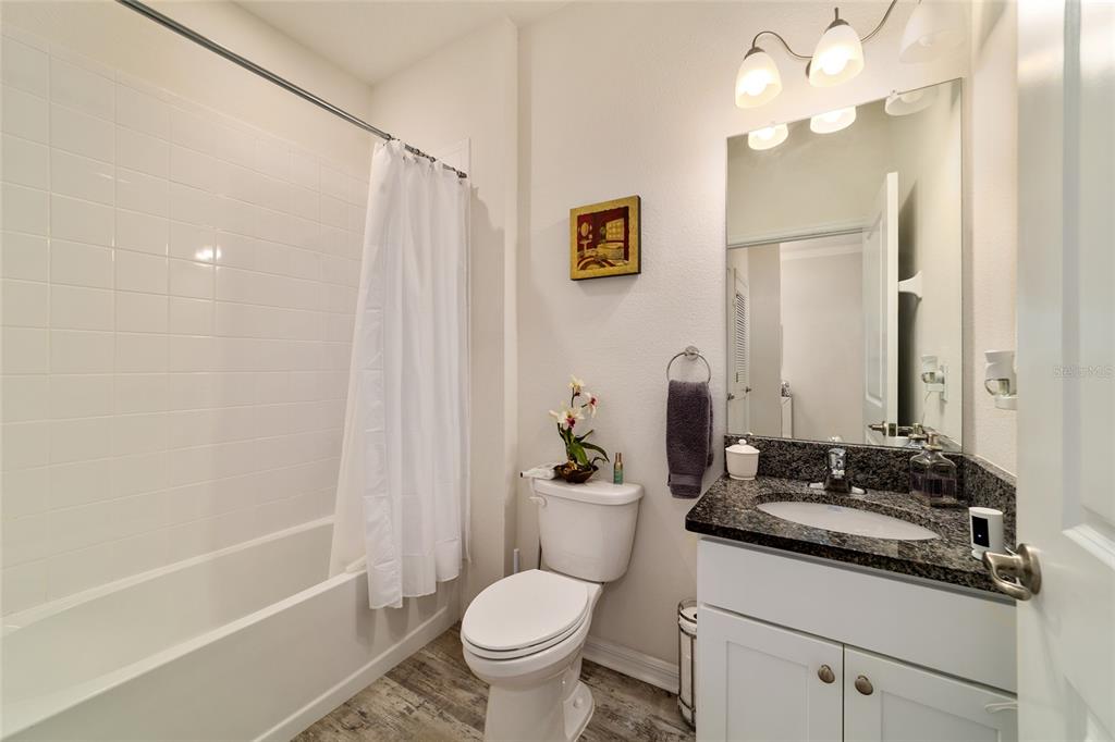 9238 Southwest 60th Terrace Road Ocala, FL 34476 - Photo 37 of 50 a bathroom with a granite countertop sink a toilet and shower