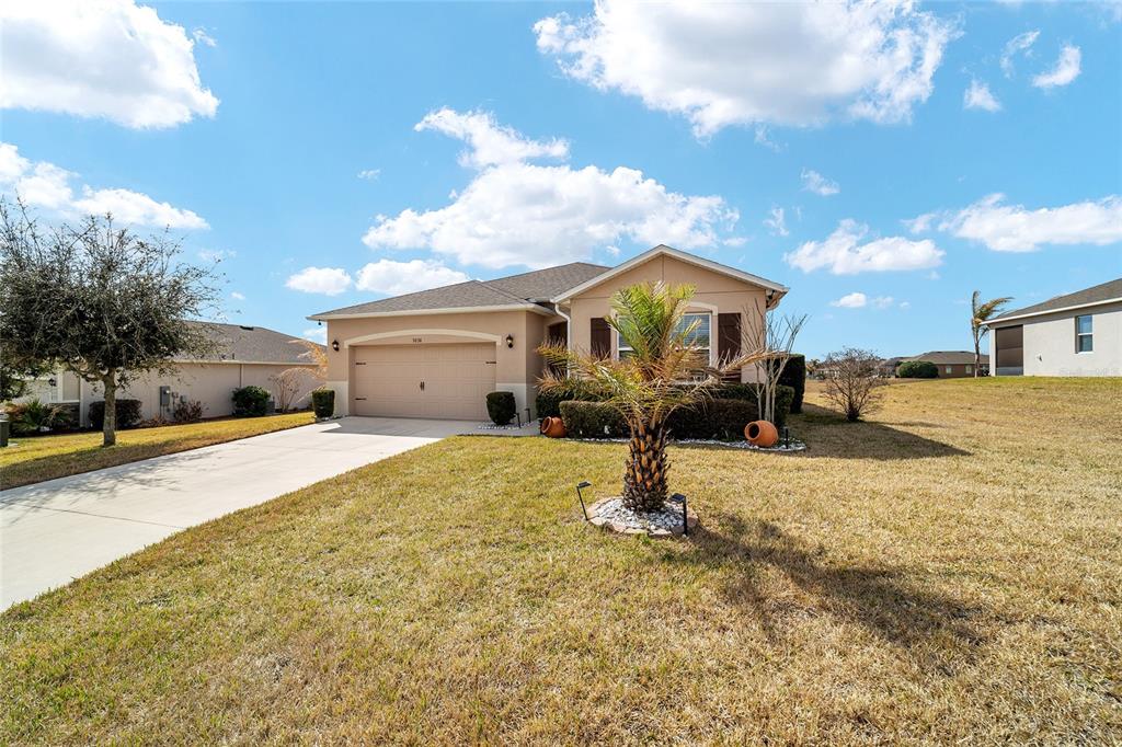 9238 Southwest 60th Terrace Road Ocala, FL 34476 - Photo 5 of 50 a front view of a house with a yard covered with snow