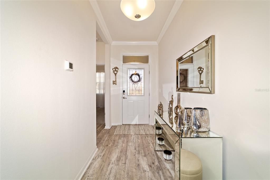 9238 Southwest 60th Terrace Road Ocala, FL 34476 - Photo 9 of 50 a view of a livingroom with wooden floor and white walls
