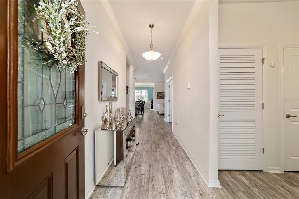 9238 Southwest 60th Terrace Road Ocala, FL 34476 - Photo 10 of 50 a view of a hallway with wooden floor and staircase