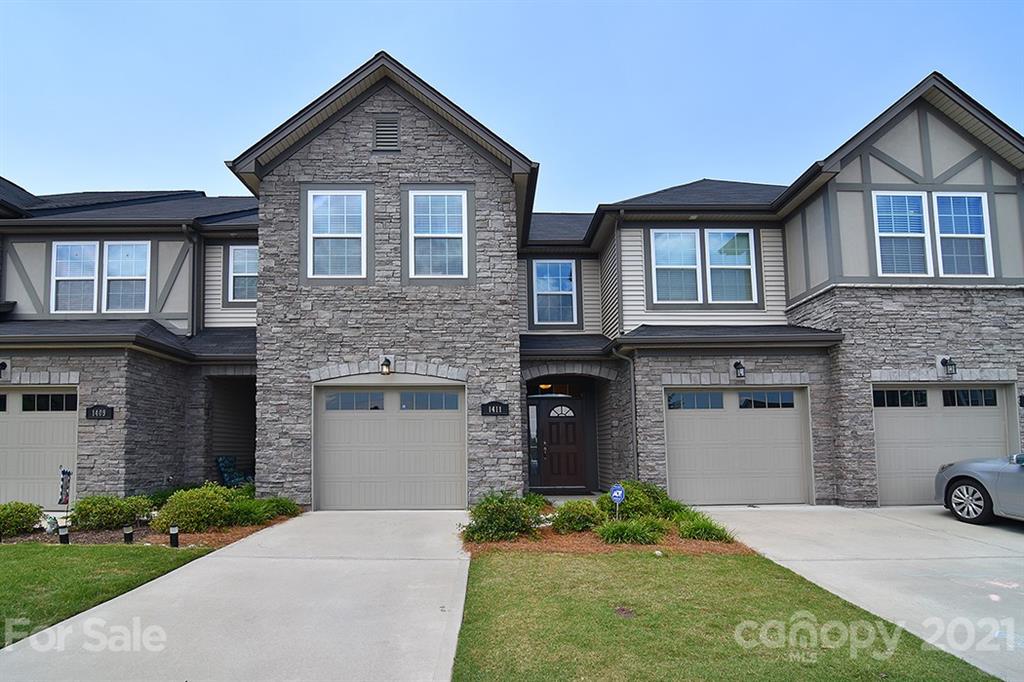 1411 Calum Way Fort Mill, SC 29708 - Photo 1 of 37 a front view of a house with a yard and garage