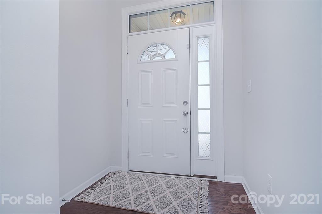 1411 Calum Way Fort Mill, SC 29708 - Photo 2 of 37 an empty room with wooden floor and entryway