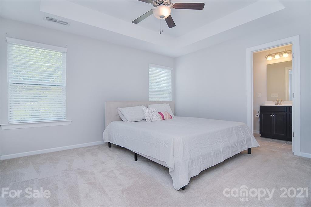 1411 Calum Way Fort Mill, SC 29708 - Photo 16 of 37 a bedroom with a bed and a ceiling fan