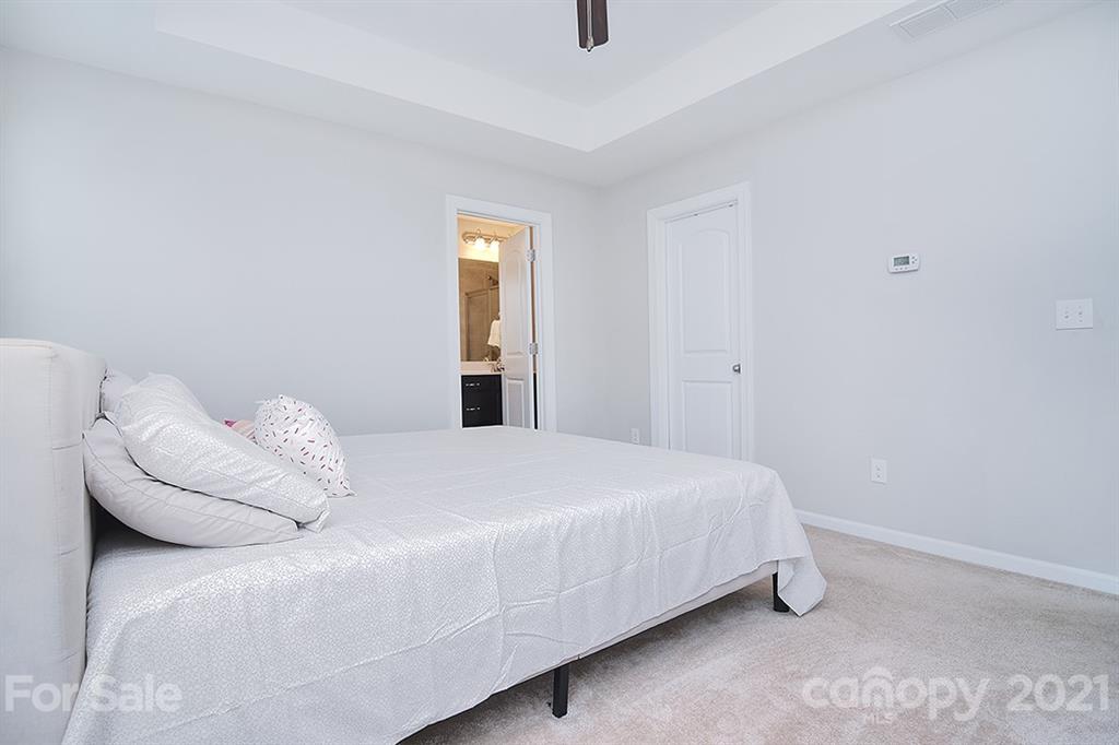 1411 Calum Way Fort Mill, SC 29708 - Photo 17 of 37 a bedroom with a bed and a night stand