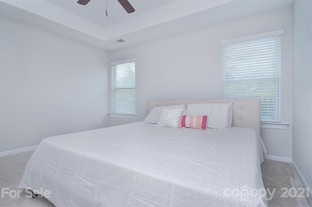 1411 Calum Way Fort Mill, SC 29708 - Photo 18 of 37 a bedroom with a bed and a ceiling fan