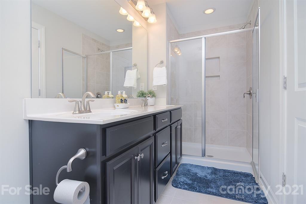 1411 Calum Way Fort Mill, SC 29708 - Photo 19 of 37 a bathroom with a sink shower and a mirror