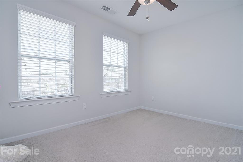1411 Calum Way Fort Mill, SC 29708 - Photo 21 of 37 an empty room with a window and a fan