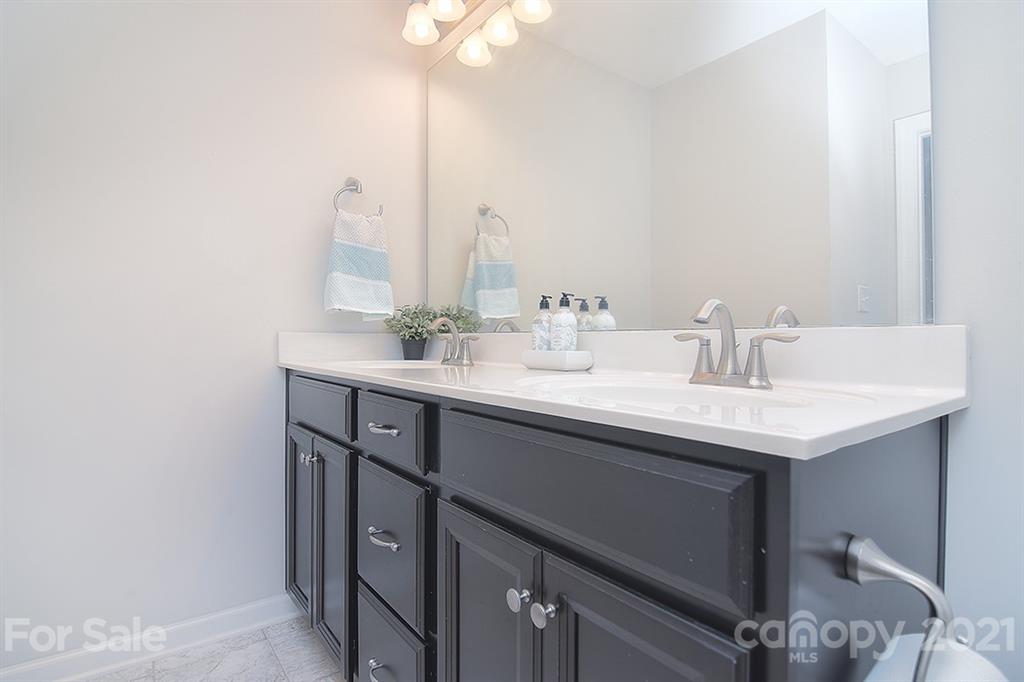 1411 Calum Way Fort Mill, SC 29708 - Photo 23 of 37 a bathroom with a sink and a mirror