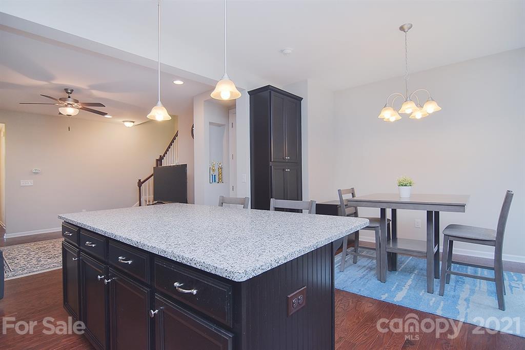 1411 Calum Way Fort Mill, SC 29708 - Photo 9 of 37 a kitchen with a table chairs and a refrigerator