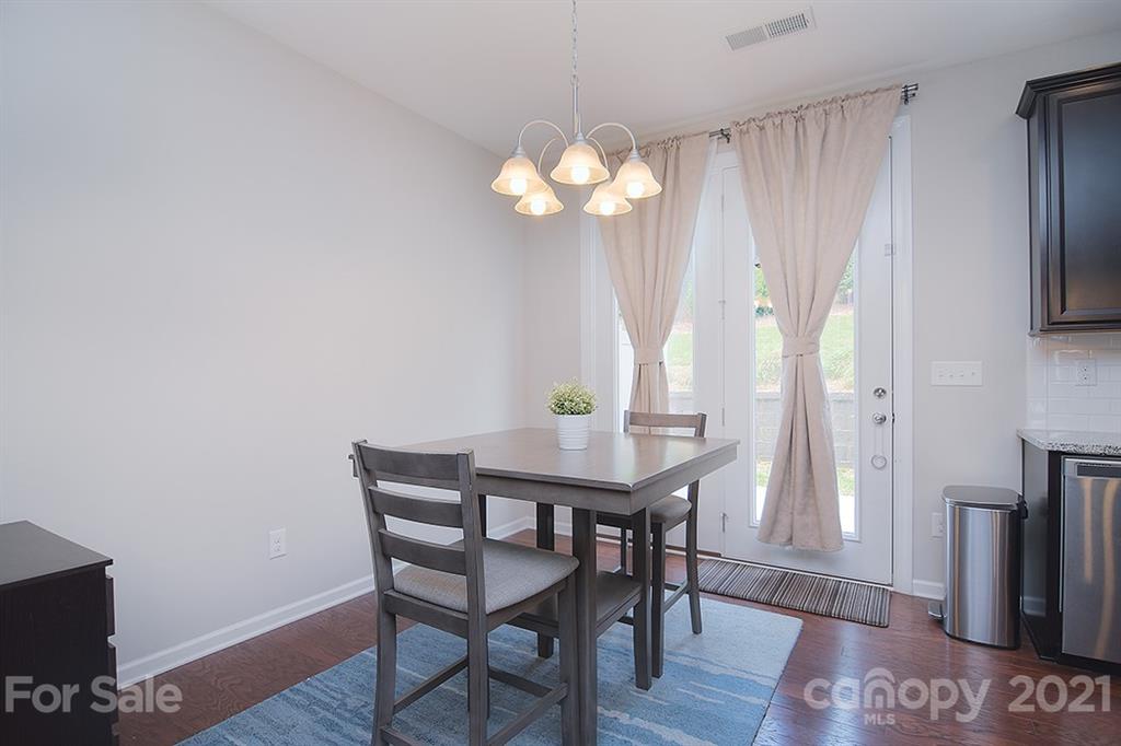 1411 Calum Way Fort Mill, SC 29708 - Photo 10 of 37 a view of a dining room with furniture window and wooden floor