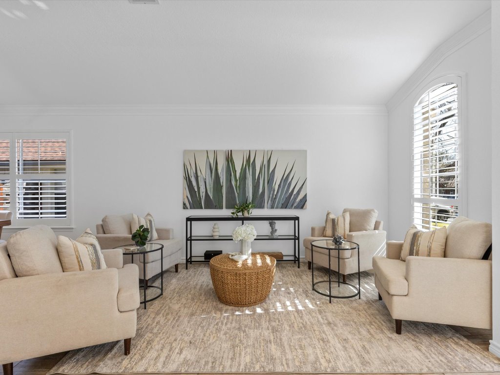 9322 Lightwood Loop Austin, TX 78748 - Photo 11 of 40 Peaceful natural light bathes the living & dinign rooms with an arching front window and plantation shutters on windows throughout the home.