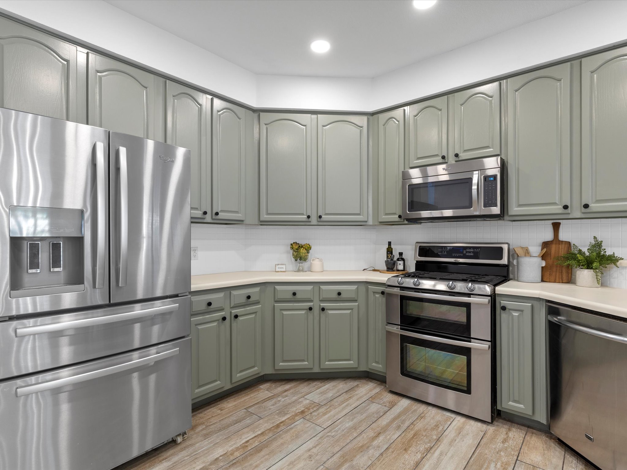 9322 Lightwood Loop Austin, TX 78748 - Photo 14 of 40 The kitchen shines with desirable stainless steel appliances and beautifully painted cabinetry that adds timeless allure.