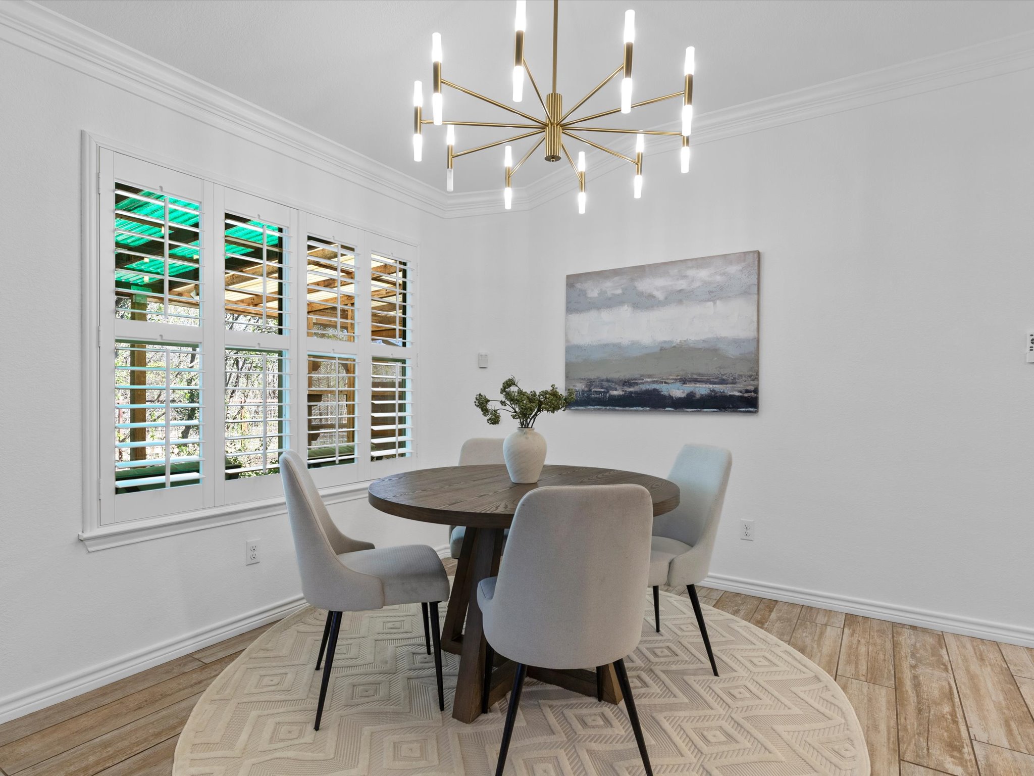 9322 Lightwood Loop Austin, TX 78748 - Photo 16 of 40 The breakfast area sits alongside windows with serene greenbelt views and boasts a gorgeous contemporary chandelier.