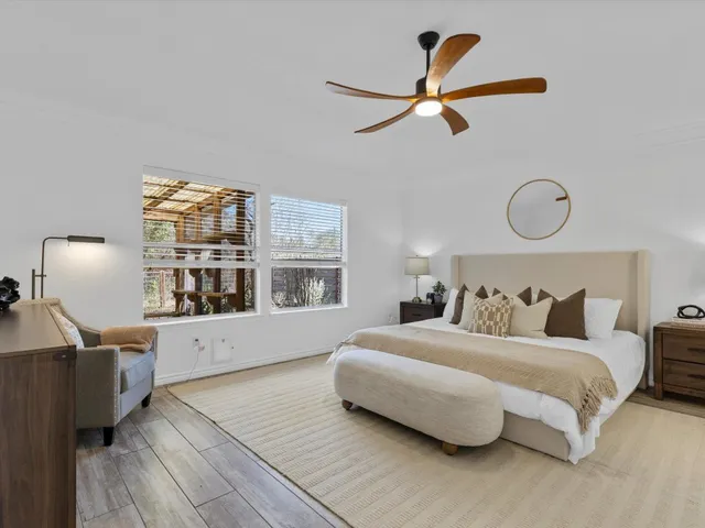 a bedroom with a large bed and a window