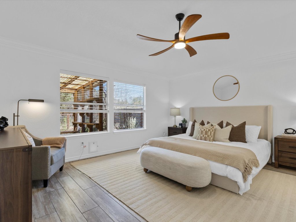 9322 Lightwood Loop Austin, TX 78748 - Photo 19 of 40 The oversized and secluded primary suite overlooks the backyard and greenbelt and features a unique cat door to the Catio off the back porch.