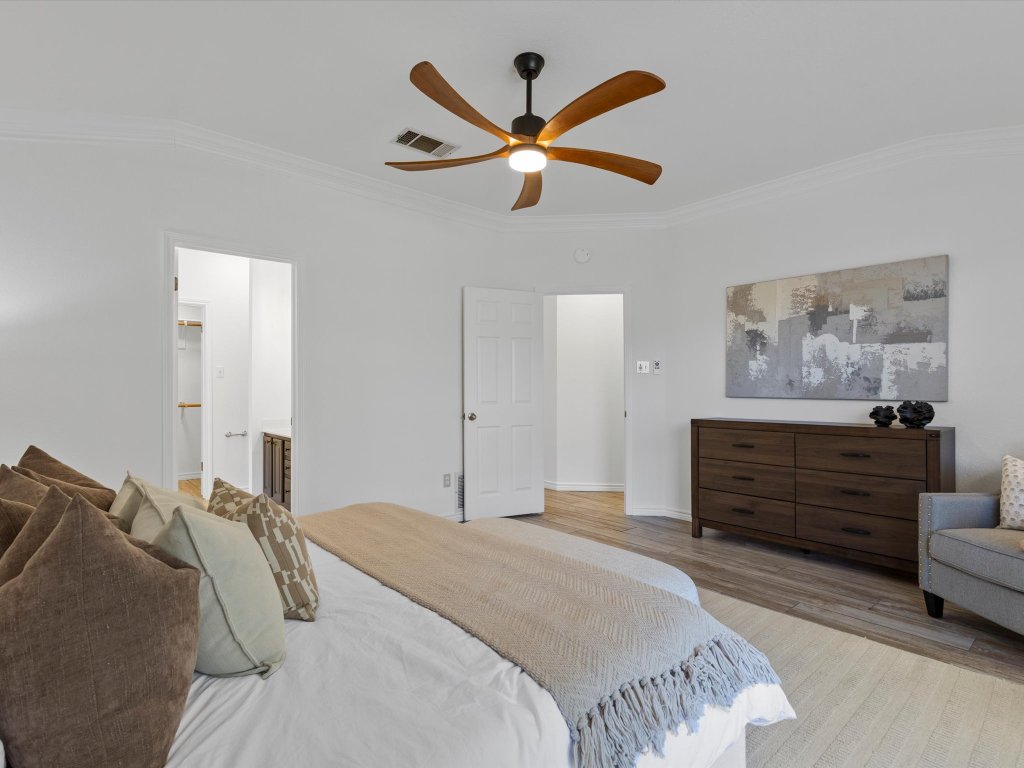 9322 Lightwood Loop Austin, TX 78748 - Photo 20 of 40 A modern ceiling fan keeps the breeze flowing while the size of the room allows room for your king sized bed, furniture and even a seating area.