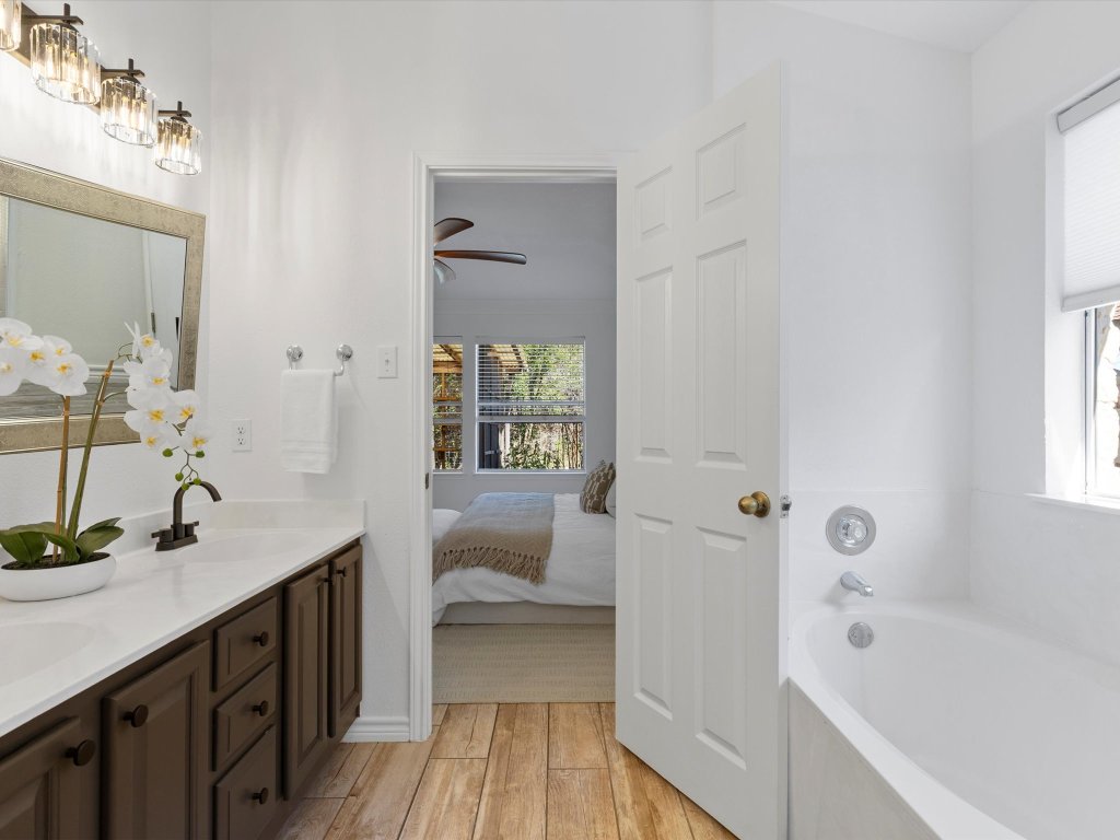 9322 Lightwood Loop Austin, TX 78748 - Photo 21 of 40 Enjoy your own private ensuite bath with a dual vanity, updated fixtures & hardware, and tastefully painted cabinetry.